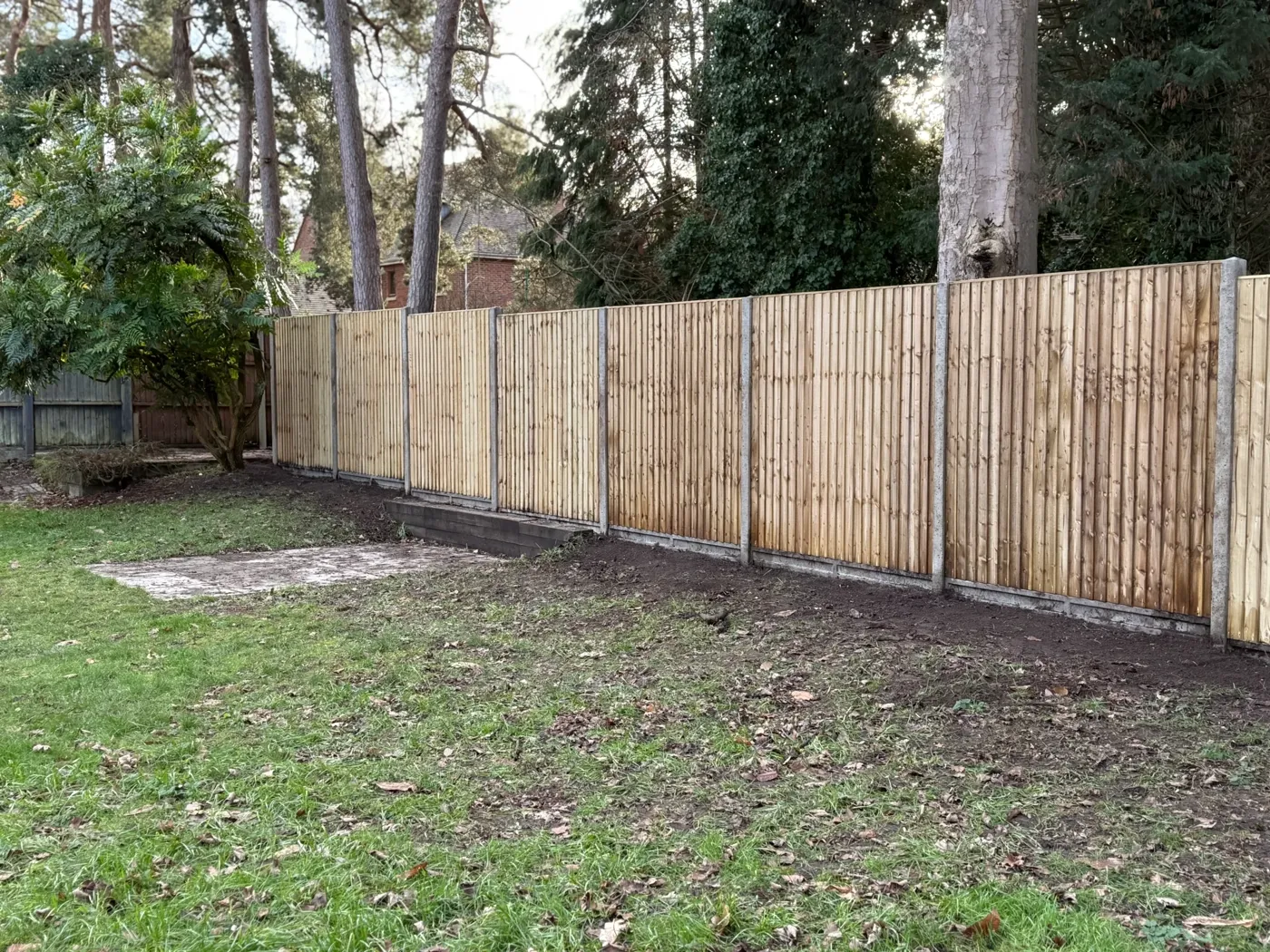 Closeboard boundary fence running the length of a large garden