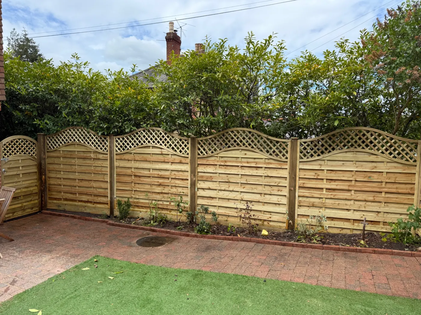 Omega trellis topped garden fence panels installed in Guildford