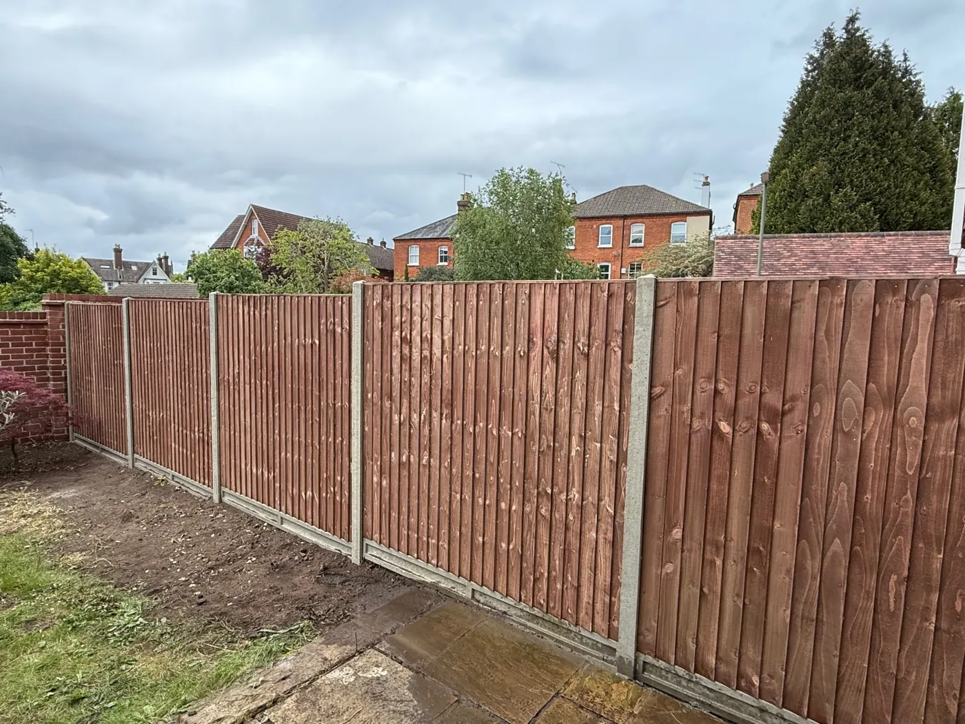 Feather edge fencing with concrete posts and gravel boards in Guildford