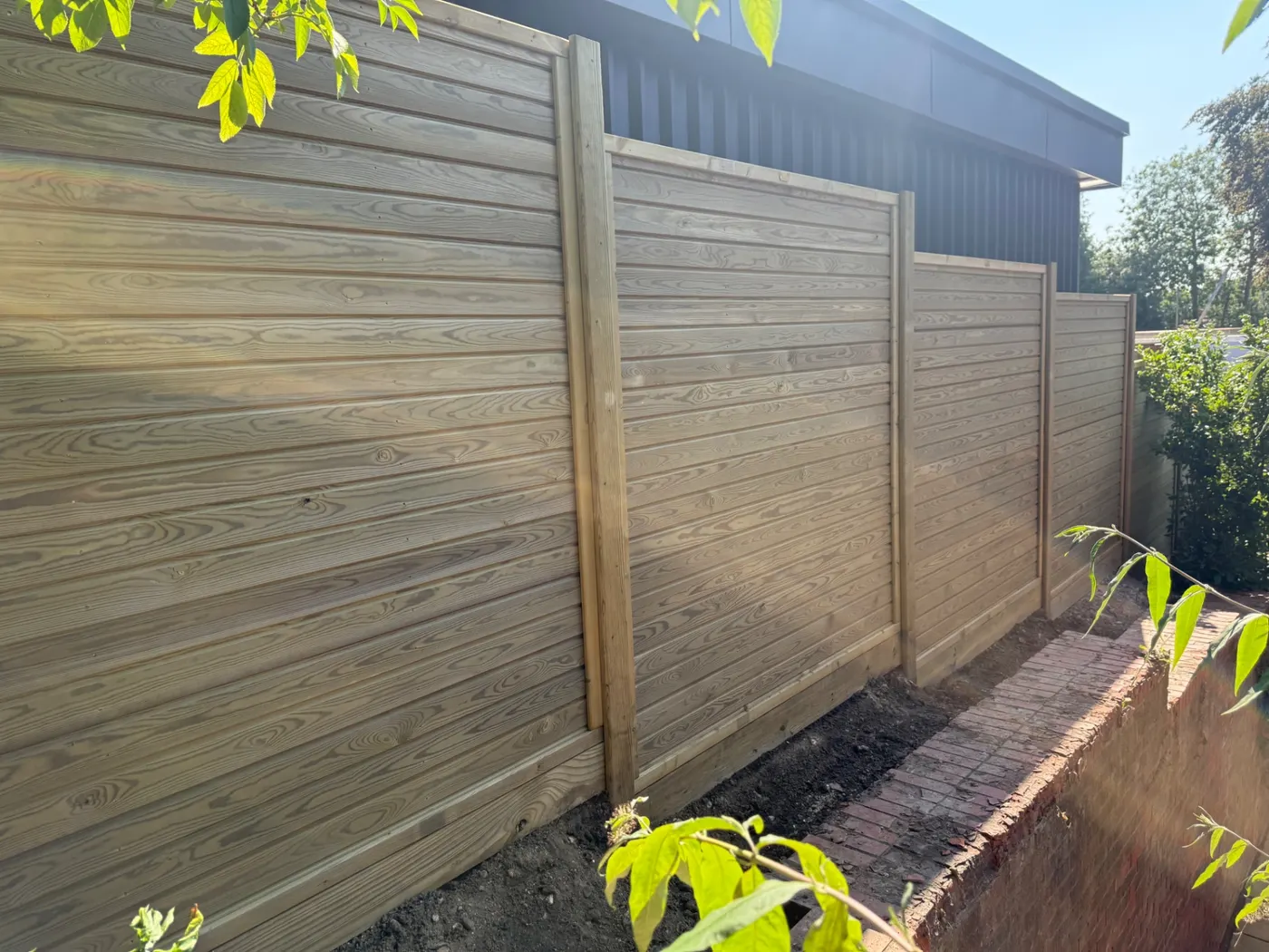 Horizontal tongue and groove fence panels installed in a Guildford garden