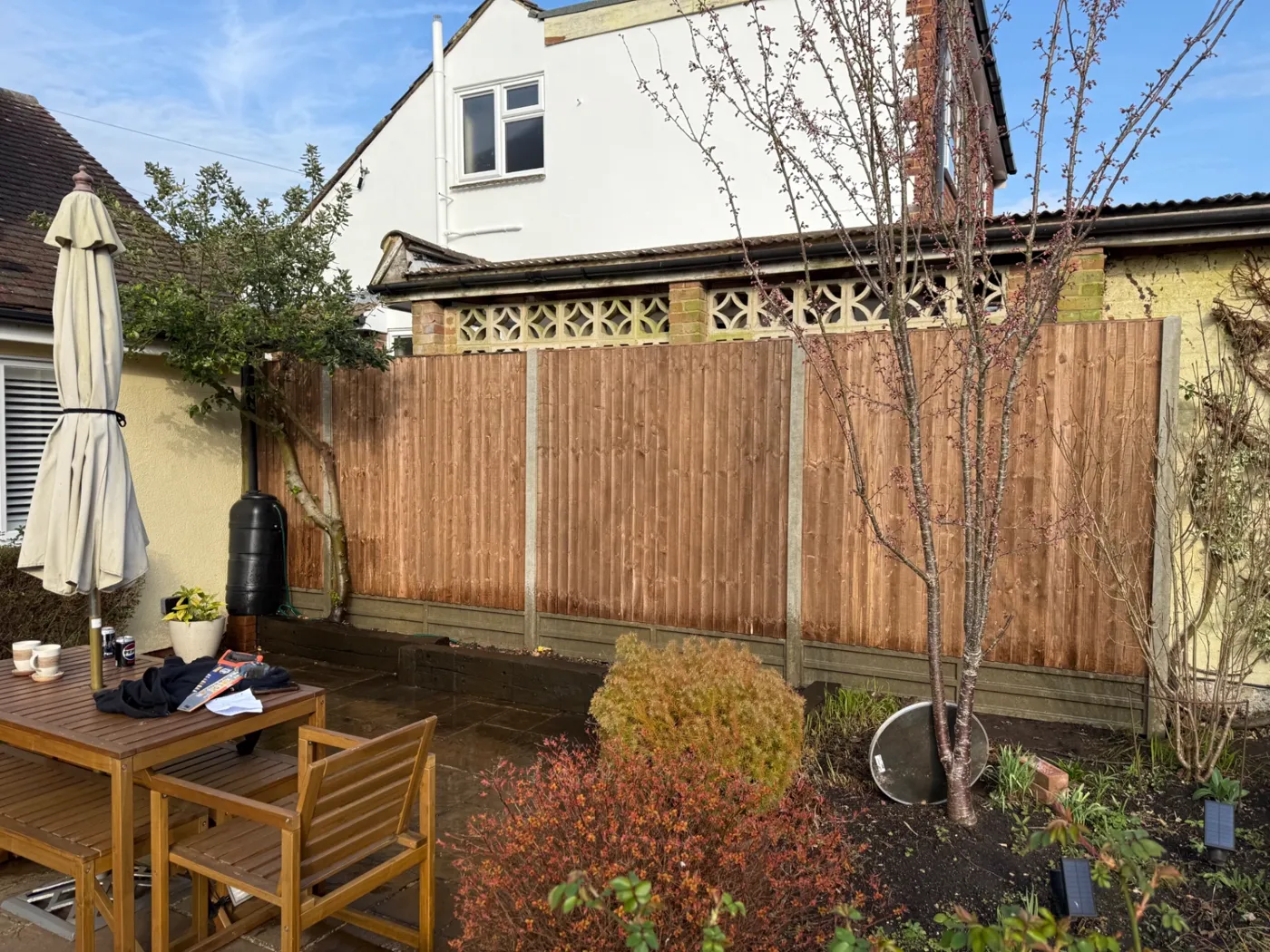 Closeboard fencing and gravel boards behind a patio in Guildford