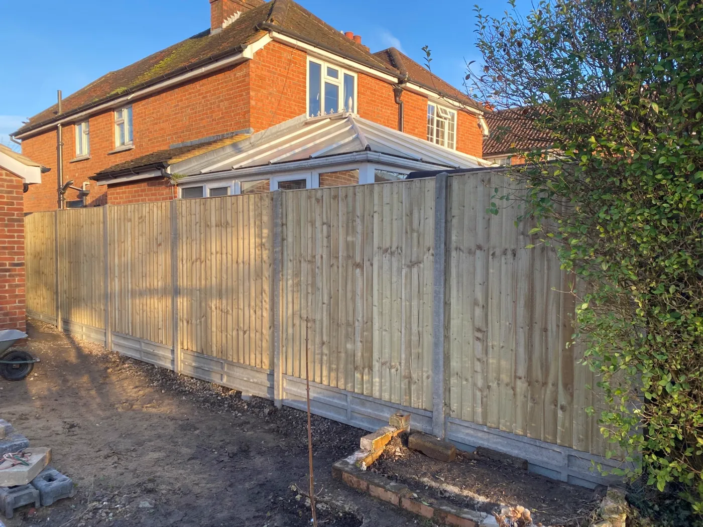 New closeboard fence installation with concrete posts and gravel boards at a Guildford home