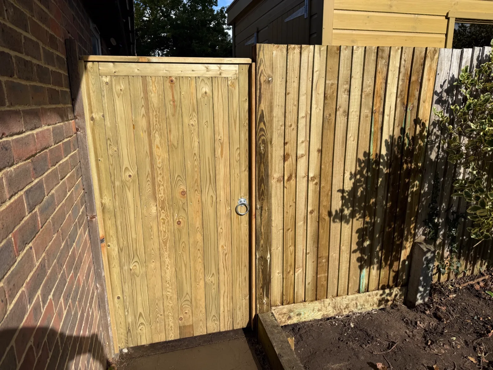 New tongue and groove side gate fitted beside a house in Guildford