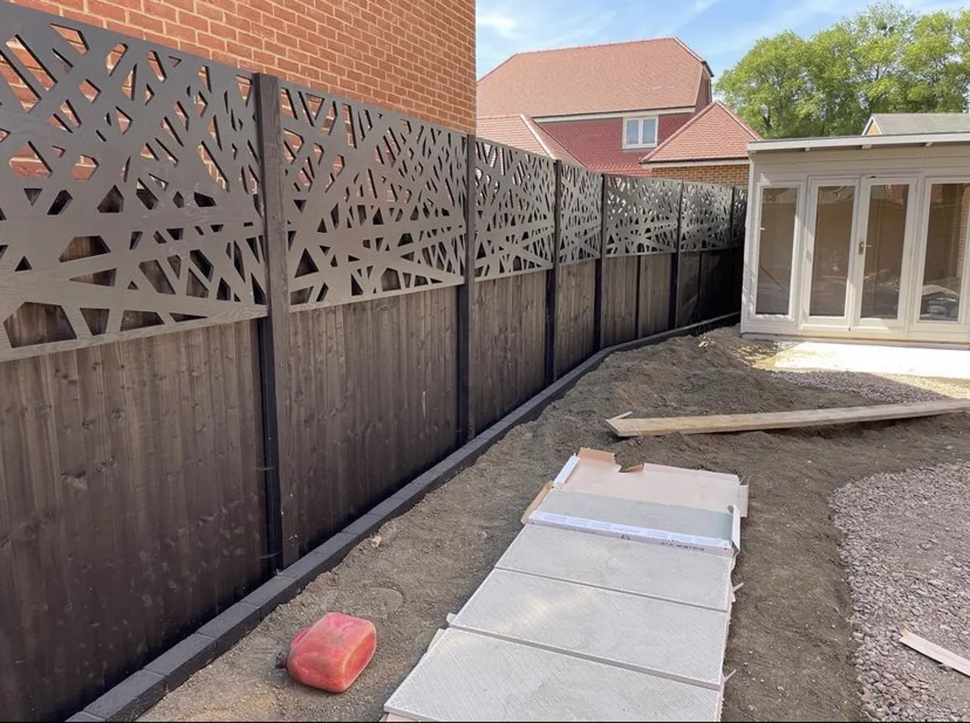 Decorative laser cut fence toppers fitted above garden fence panels