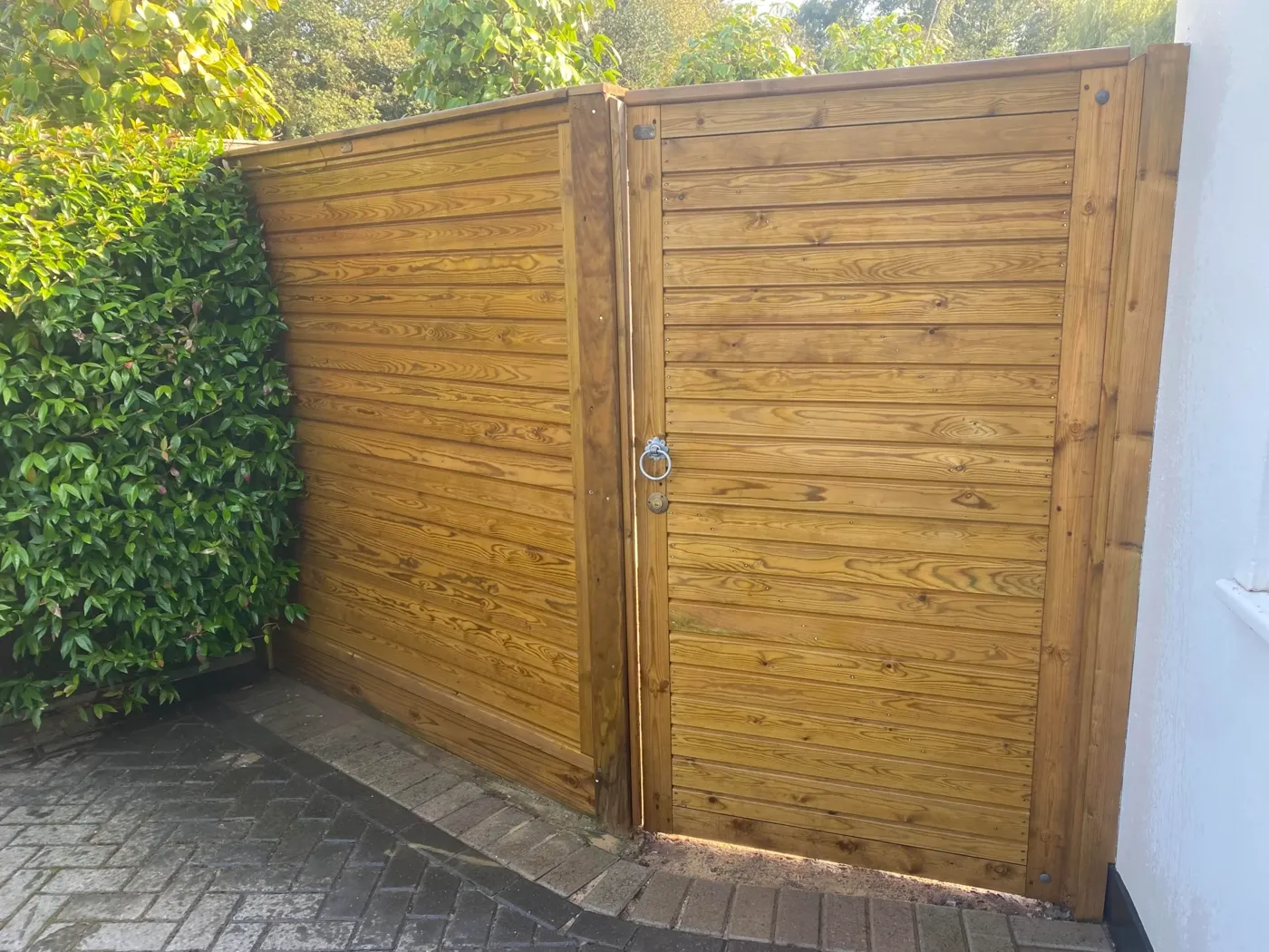 Timber garden gate fitted between fence posts